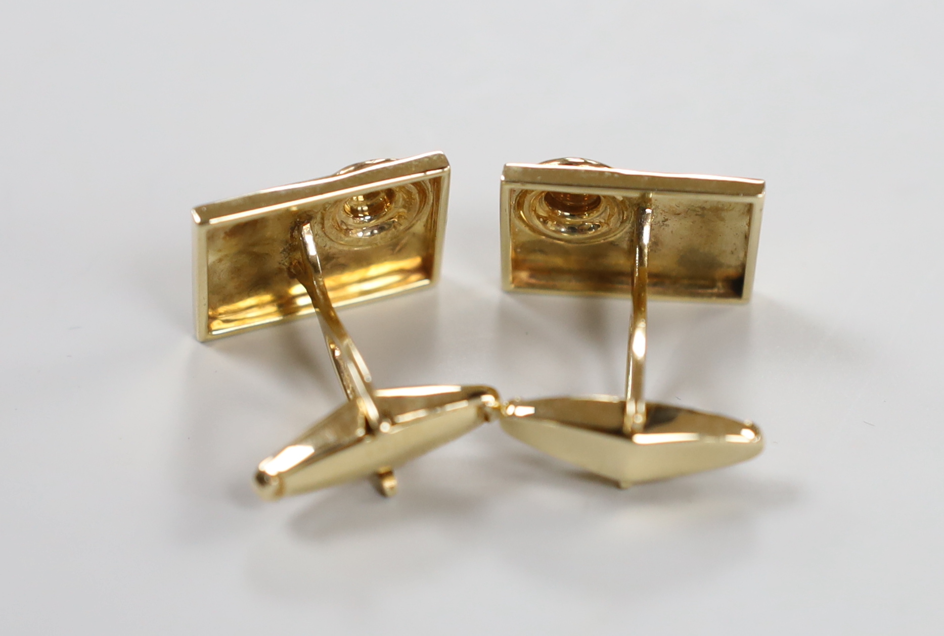 A modern pair of 14k yellow metal and sapphire cluster set rectangular cufflinks, 19mm, gross weight 11.6 grams.